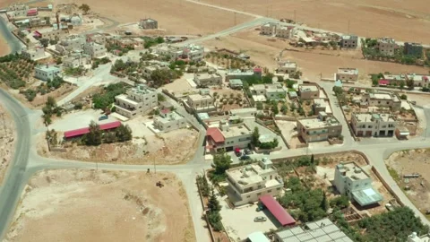 Drone aerial shot of developing rural town in Jordan - sunny day Stock Footage 297236764