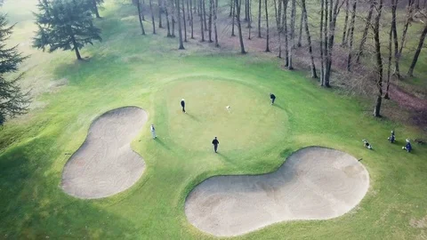 Drone aerial shot: golfers play on a golf course near the last hole Video stock 85383053