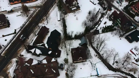 Drone aerial shot moving forward and up showing snowing city and mountains Video stock 151524910