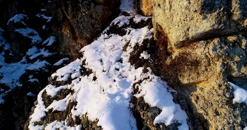 Drone Aerial Shot Rising Up, flying near to rock covered with snow Stock Footage