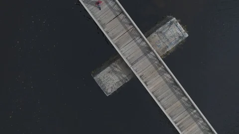 Drone aerial shot of a walking bridge with people walking Stock Footage
