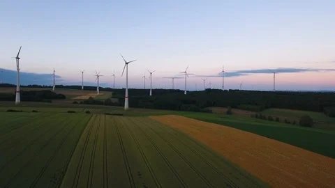 Drone aerial slow left parallel flying wind turbine farm in a large open Stock Footage 120074362