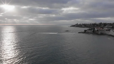 Drone Aerial of Sun Rays Breaking Through Clouds Over La Jolla Coastline - (UHD Stock Footage 342593155