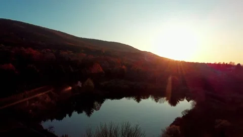 Drone Aerial Sunset Over Lake Mountain Silhouette Stock Footage