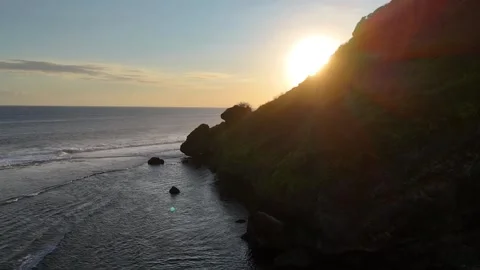 Drone Aerial of Sunset Over Ocean Cliffs in Bali Indonesia Video stock 330476449