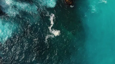 Drone Aerial top down shot of Ceningan Blue Lagoon sea and cliff Stock Footage 115014046