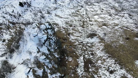 Drone aerial top down view over the rock with snow, wild natural landscape 4k Stock Footage 148031522