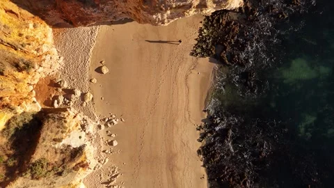 Drone Aerial top down view of people walking on the beach of Praia Dona Ana Video stock 318846087