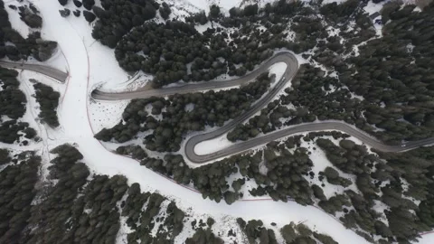 Drone aerial top down of windy Winter Roads in Italian Alps IT ALP DJI 0160 B Stock Footage 139946534