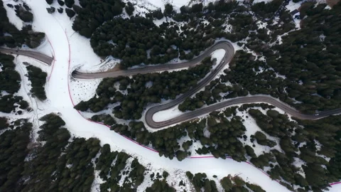 Drone aerial top down of windy Winter Roads in Italian Alps IT ALP 0160 B GR Stock Footage 143291779