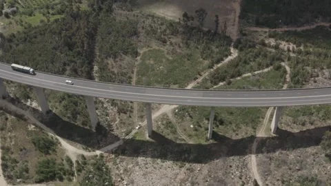 Drone aerial traffic passing on elevated road in mountain valley side on hig Stock Footage 277386188