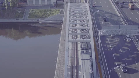 Drone aerial of train crossing bridge over river, D-Log footage Stock Footage 320739060