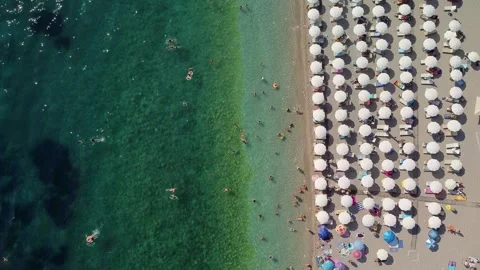 Drone aerial view of a beach filled with people on a hot summer day Stock Footage 262177932