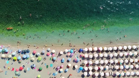 Drone aerial view of a beach filled with people on a hot summer day Stock Footage 262293060
