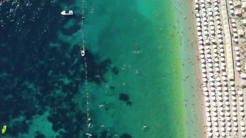 Drone aerial view of a beach filled with people on a hot summer Stock Footage 263176268