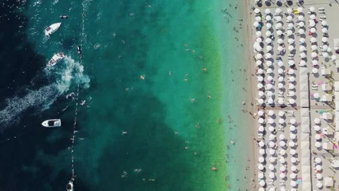 Drone aerial view of a beach filled with people on a hot summer Stock Footage 270244832