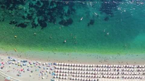 Drone aerial view of a beach filled with people on a hot summer day Stock Footage 289639138