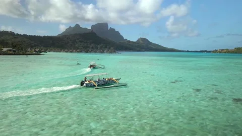 Drone aerial view Bora Bora Tahiti, 4k. boat in blue lagoon. French Polynesia.  Stock Footage 143576344