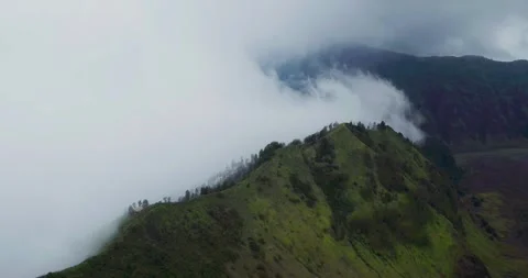 Drone Aerial View of Bromo Volcano Crater with Foggy Mountain Terrain Stock Footage 333846005