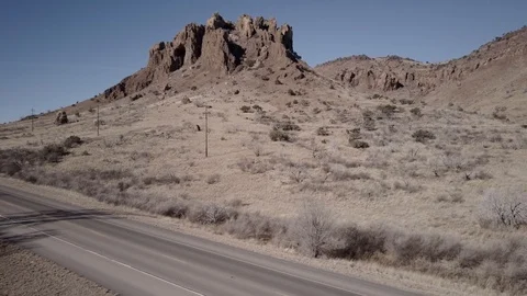 Drone Aerial View of Chisos Mountain vertical climb with cars passing Stock Footage 92539083