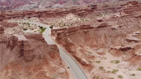 Drone Aerial View Of Empty Road Between Red Rocks, Las Conchas Valley, Argentina Stock Footage 191754478