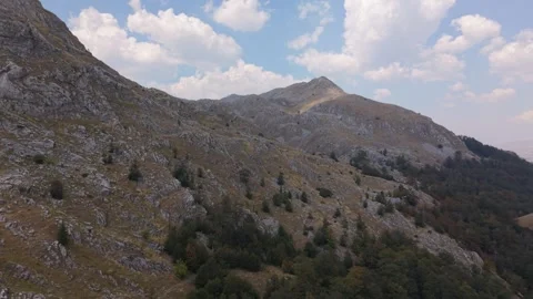 Drone Aerial View Flying Along Steep Rocky Mountain Slopes Towards Peak  Stock Footage 343673541