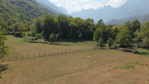 Drone Aerial View Flying Over Meadow Fence and Dry Stone Wall in Bijela Village  Stock Footage 343674949