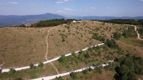 Drone Aerial View Flying Over Winding White Gravel Paths and Dry Hill Plateau  Stock-Footage 343675690