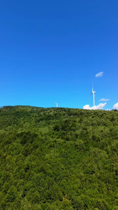 Drone Aerial View Flying Towards Wind Turbines on Mountain Ridge with Dirt Road  Vídeos de archivo 343675720