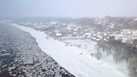 Drone aerial view flying in winter over the river near the town Stock Footage 102374894