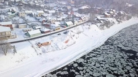 Drone aerial view flying in winter over the river full of floes near the town Stock Footage 102374967