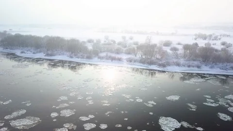 Drone aerial view flying in winter over the river in front of some trees Stock Footage 102374987