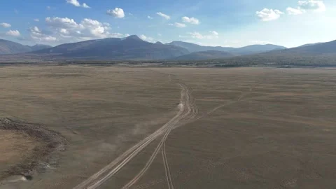 Drone aerial view of fork in desert tracks near Khoton Nuur Lake Stock Footage 348401847