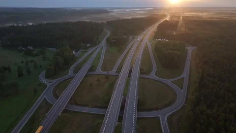 Drone Aerial View of Highway Interchange at Sunrise with Morning Mist in Latvia Vídeos de archivo 345151071
