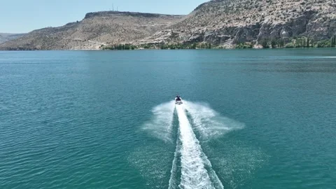 Drone Aerial View of Jet Ski Rider Speeding Across the River, May, 11, 2023, Stock Footage 336453973