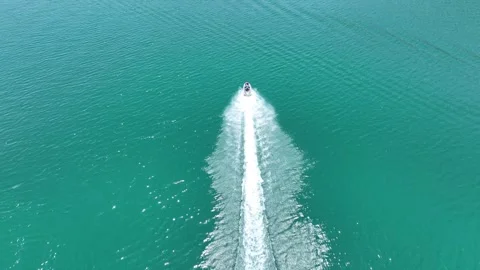 Drone Aerial View of Jet Ski Rider Speeding Across the River, May, 11, 2023, Stock Footage 336454099