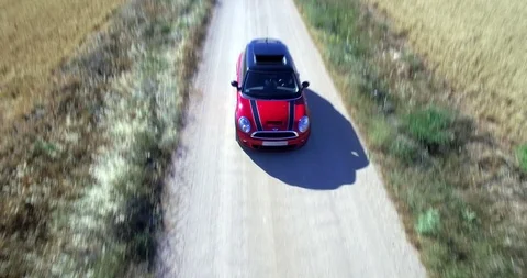 Drone aerial view of Mini Cooper car while driving Stock Footage 106117761