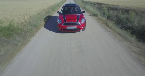Drone aerial view of Mini Cooper car while driving Stock Footage 106121047