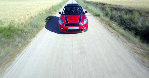 Drone aerial view of Mini Cooper car while driving Stock Footage 106121193