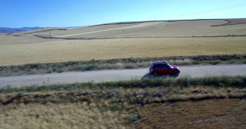 Drone aerial view of Mini Cooper car while driving Stock Footage 106122026