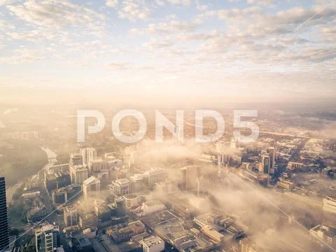 Drone aerial view of a misty foggy morning in a bustling downtown central bus Stock Photos
