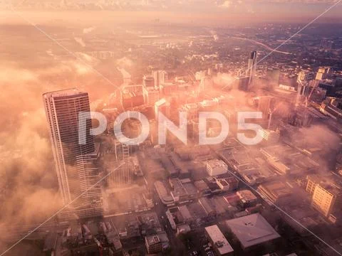 Drone aerial view of a misty foggy morning in a bustling downtown central bus Stock Photos