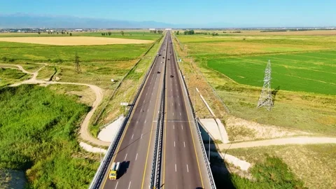 Drone Aerial View of Modern Highway Through Agricultural Landscape and Rural Cou Stock Footage 340236768