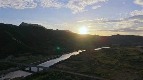 Drone aerial view of a mountain valley river bridge at sunset Stock Footage 336610411