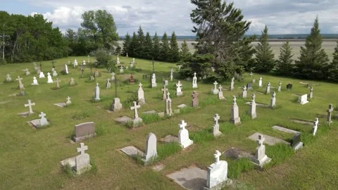 A drone aerial view moving forward over a lonely looking prairie graveyard. Stock Footage 277614638