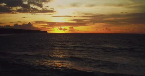 Drone Aerial View of Ocean Waves Under Dramatic Sunset Sky Stock Footage 330591947