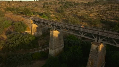 Drone Aerial View of Old Stone Bridge with Rail-Bikes near Marvao, Portugal Stock Footage 317332060