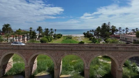 Drone aerial view of old stone bridge and beach coastline in Dehesa de Campoamor 스톡 동영상 320731598