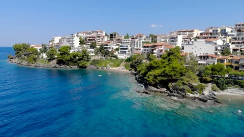 Drone aerial view over blue sea water on coast of Neos Marmaras town on the S Stock Footage 99748929