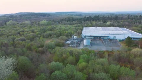 Drone Aerial View Over Warehouse with Loading Bays Surrounded by Forest 스톡 동영상 333800421